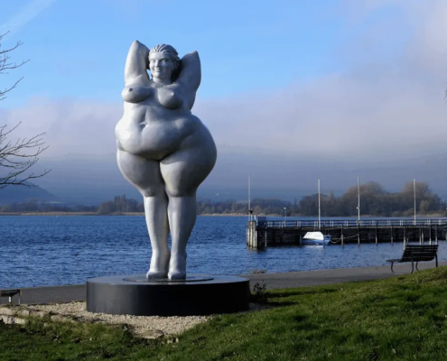 Voluptuous woman statue in a port