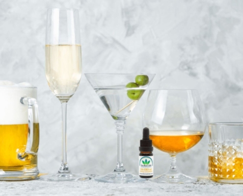 CBD oil and alcohol line up on a table