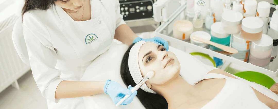 Beautician giving a woman a facial treatment in a beauty salon