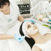 Beautician giving a woman a facial treatment in a beauty salon