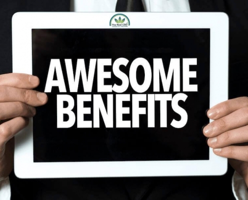 Man holding a sign saying "Awesome Benefits"