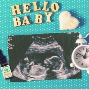 Huile de CBD et échographie de grossesse sur une surface en pointillés avec les mots HALLO BABY