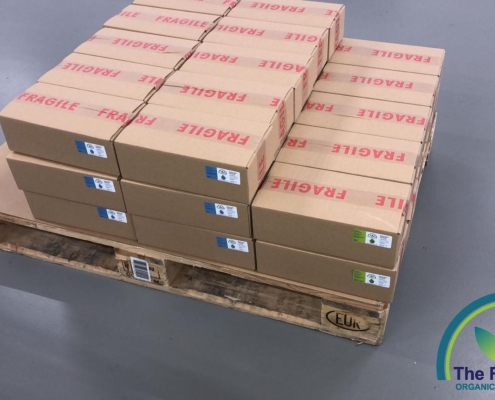 Boxes of The Real CBD oils on a pallet