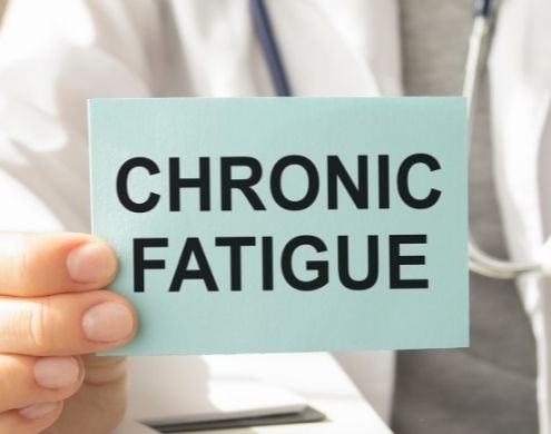 Doctor holding a chronic fatigue sign
