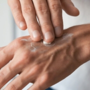 Hand applying crème onto the opposite hand