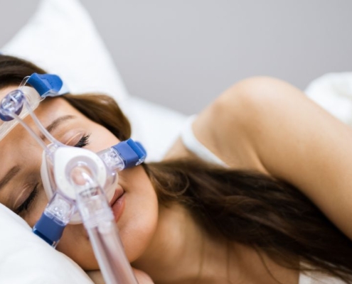 Woman sleeping with an oxygen mask on