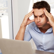 Man looking frustrated at a laptop screen
