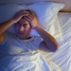 Person in bed at night unable to sleep