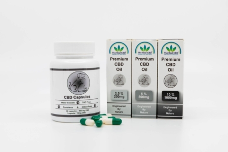 3 boxes with CBD oil and a jar of CBD capsules for pets - The Real CBD Brand