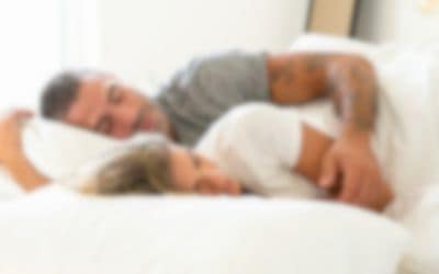 Blurred couple a sleep in a bed