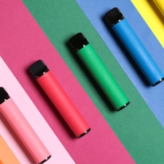 Multicoloured vape pens on a stripy matching background