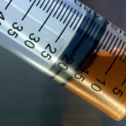 Close-up of brown oil in syringe