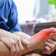 Man holding his foot with signs of Gout