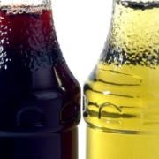 Different coloured liquid in bottles in a line