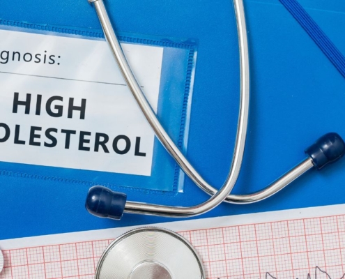 High cholesterol file with capsules and stethoscope