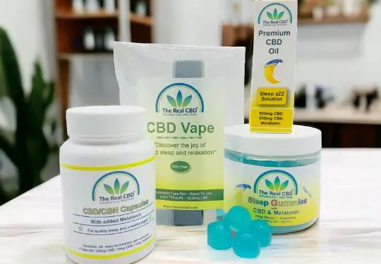 CBD sleep products on a wood table top in a shop - The Real CBD Brand