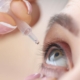 Woman dropping her eye with eye drops