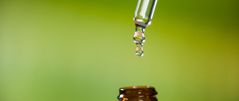 Pipette dripping liquid into bottle