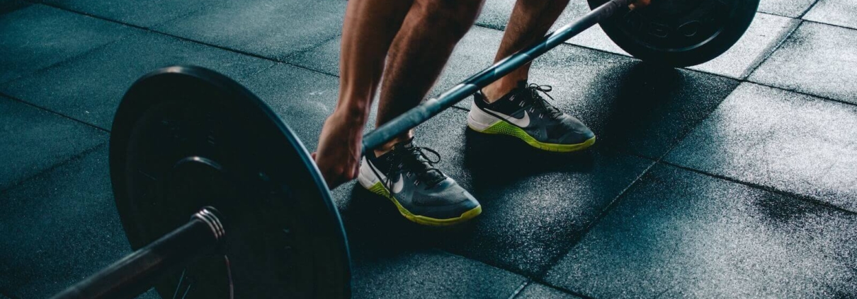 Athlete lifting a bar bell from the floor