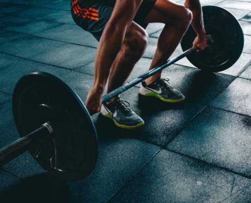 Athlete lifting a bar bell from the floor