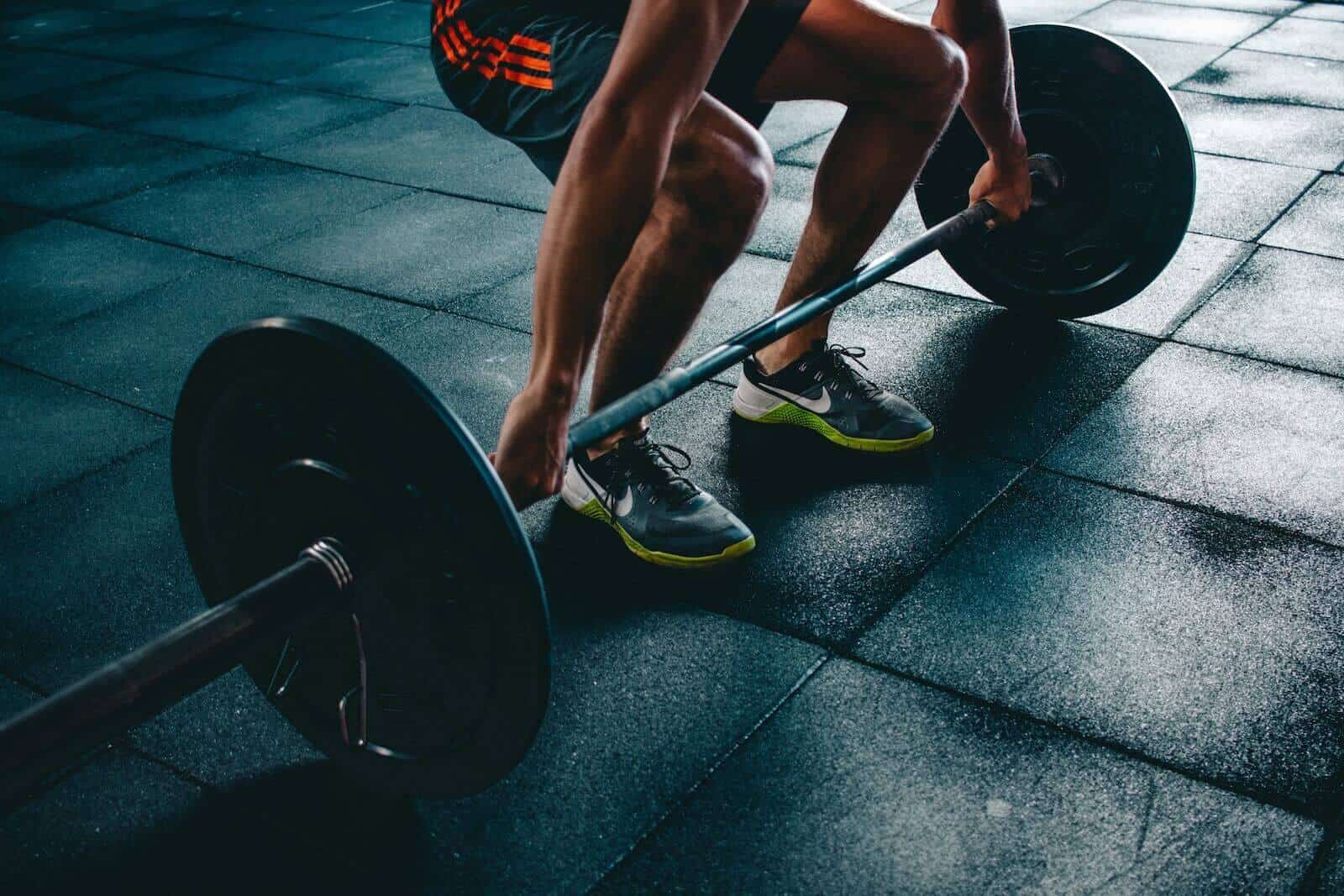 Athlete lifting a bar bell from the floor