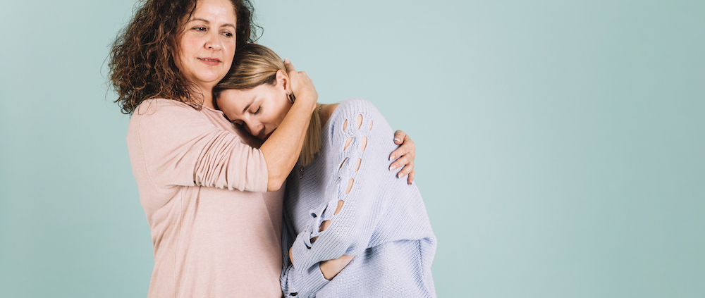 Mother comforting a teenager