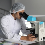 Scientist looking into a microscope