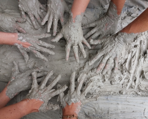 CBD Bentonite Clay hands in mudpile