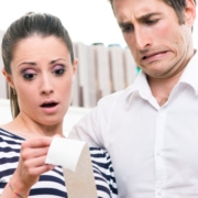 Disgusted couple looking at receipt