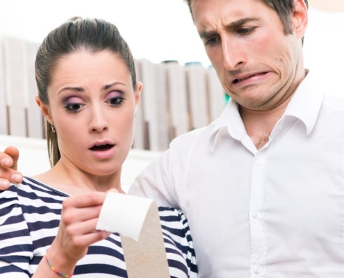 Disgusted couple looking at receipt