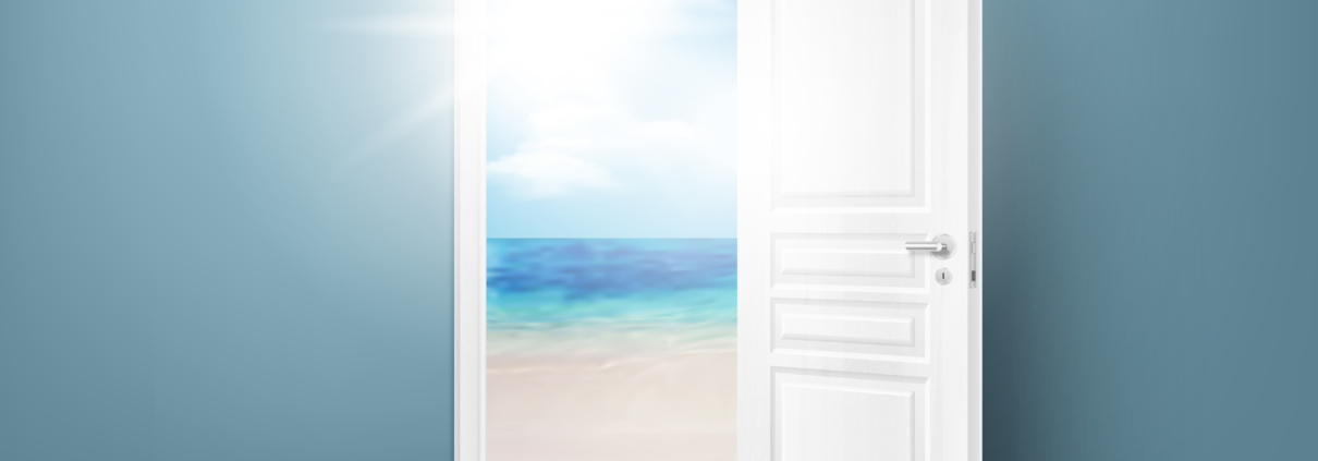 White door open onto a beach with sunlight