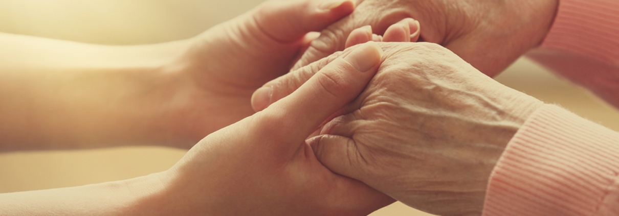 Young and old hand holding eachother