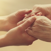 Young and old hand holding eachother