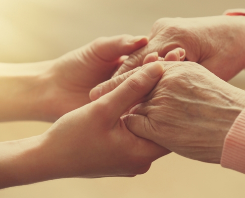 Young and old hand holding eachother