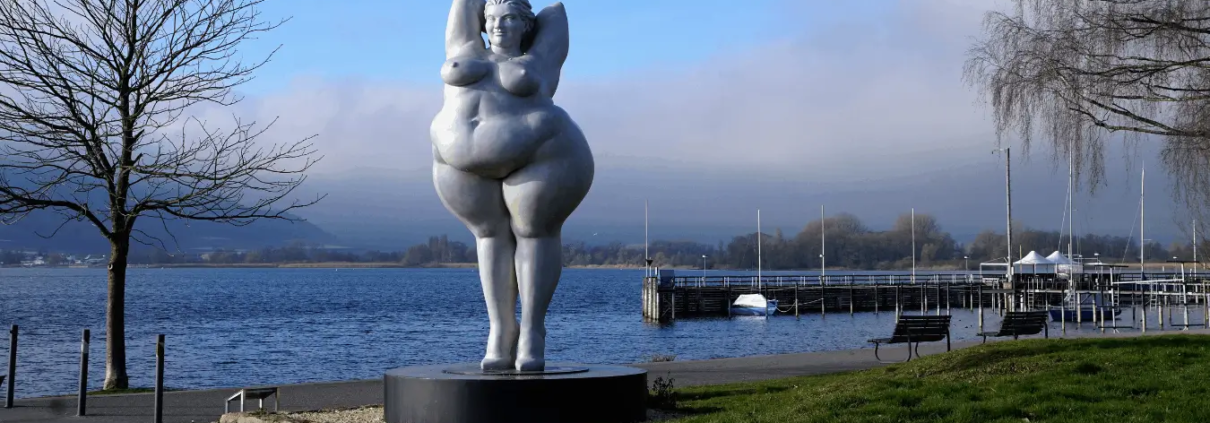 Voluptuous woman statue in a port