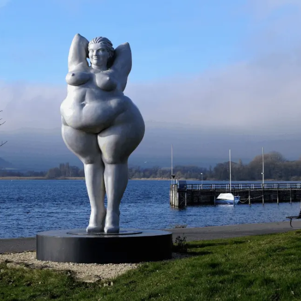 Voluptuous woman statue in a port