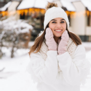 Woman in snow scene looking happy and smiling