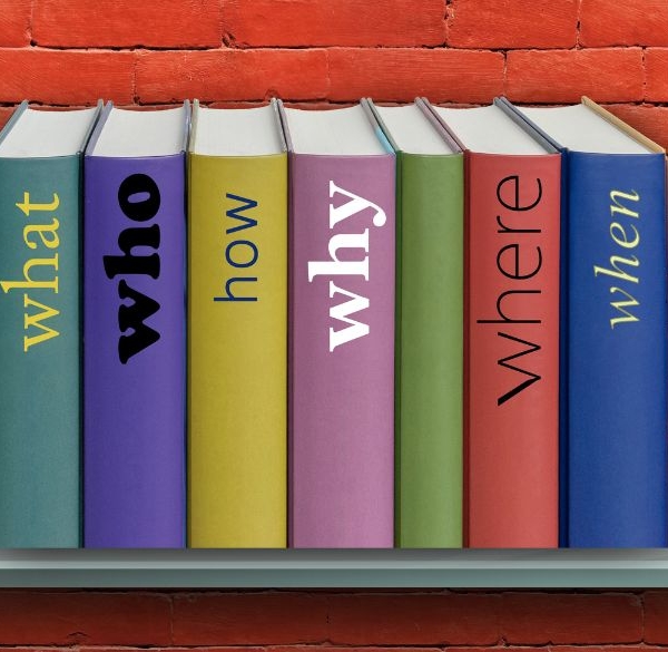 Shelf on red brick wall with line-up of books with questions as titles