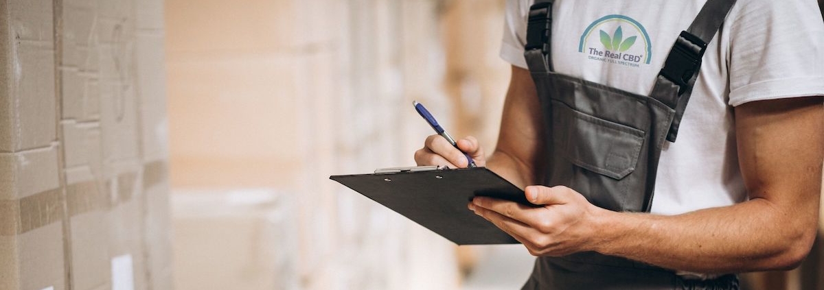 Warehouseman holding a clipboard taking stock