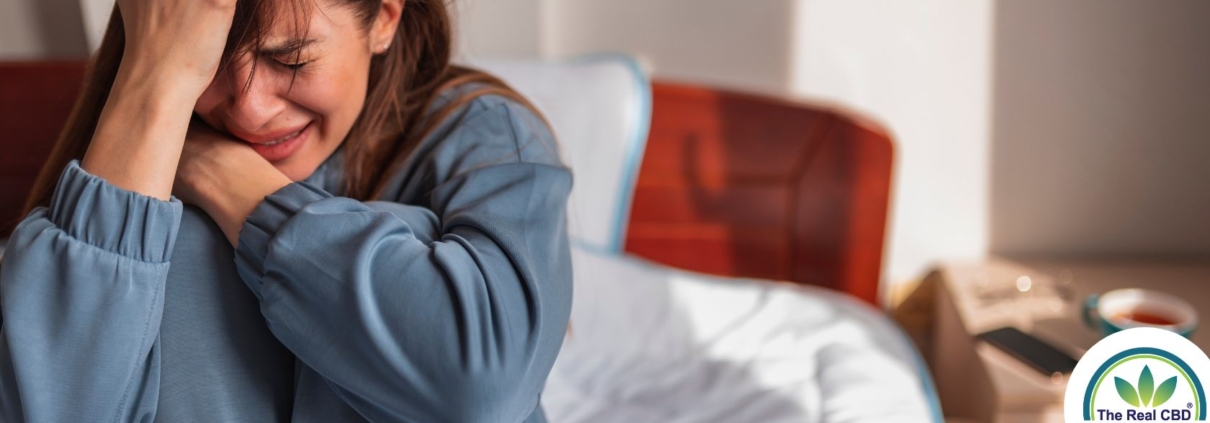 Crying girl sitting on a bed