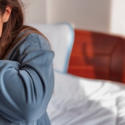 Crying girl sitting on a bed