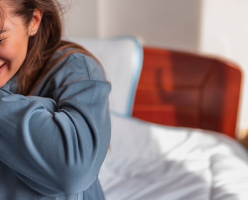 Crying girl sitting on a bed