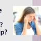 Woman holding her head in front of a migraine road sign