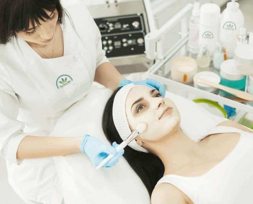 Beautician giving a woman a facial treatment in a beauty salon