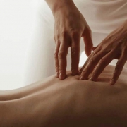 Hands massaging the back of a woman