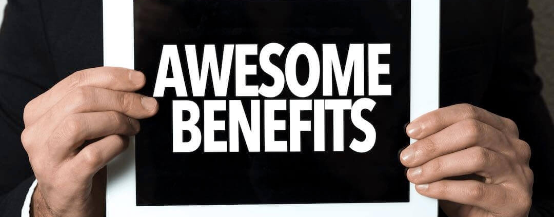 Man holding a sign saying "Awesome Benefits"