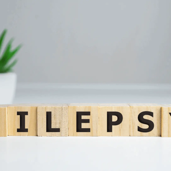 Epilepsy spelled out on wood blocks with CBD oil on the side