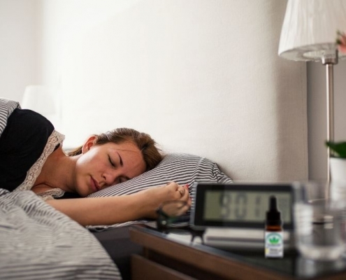 Woman asleep in light bedroom