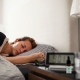 Woman asleep in light bedroom