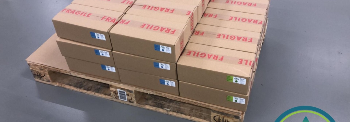 Boxes of The Real CBD oils on a pallet